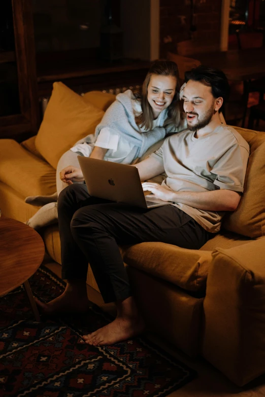 a man and woman sitting on a couch with a laptop, pexels contest winner, comfy lighting, movie clip, happy couple, instagram picture