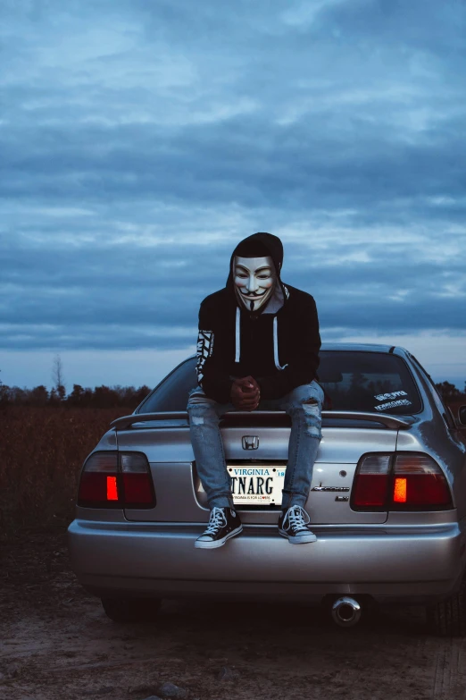 a man wearing a mask sitting on top of a car, an album cover, pexels contest winner, anonymous as a car, hacker, 15081959 21121991 01012000 4k, ( 3 1