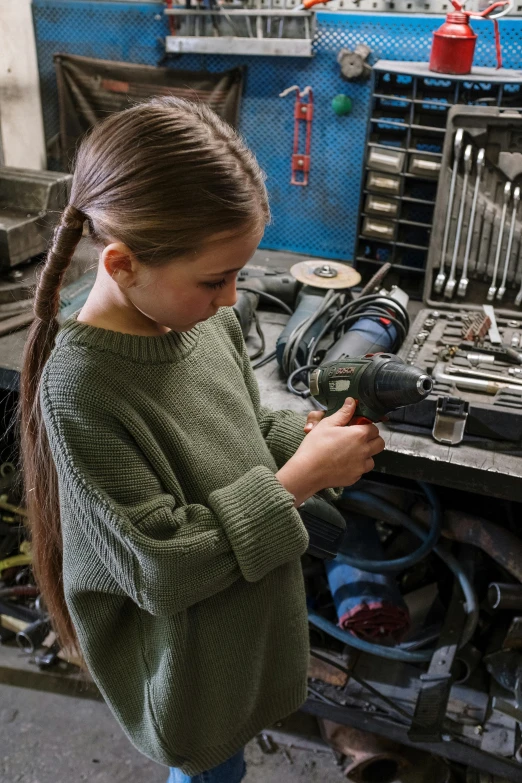 a young girl working on a machine in a workshop, by Jakob Gauermann, pexels contest winner, promo image, gunsmithing, greta thunberg, 15081959 21121991 01012000 4k