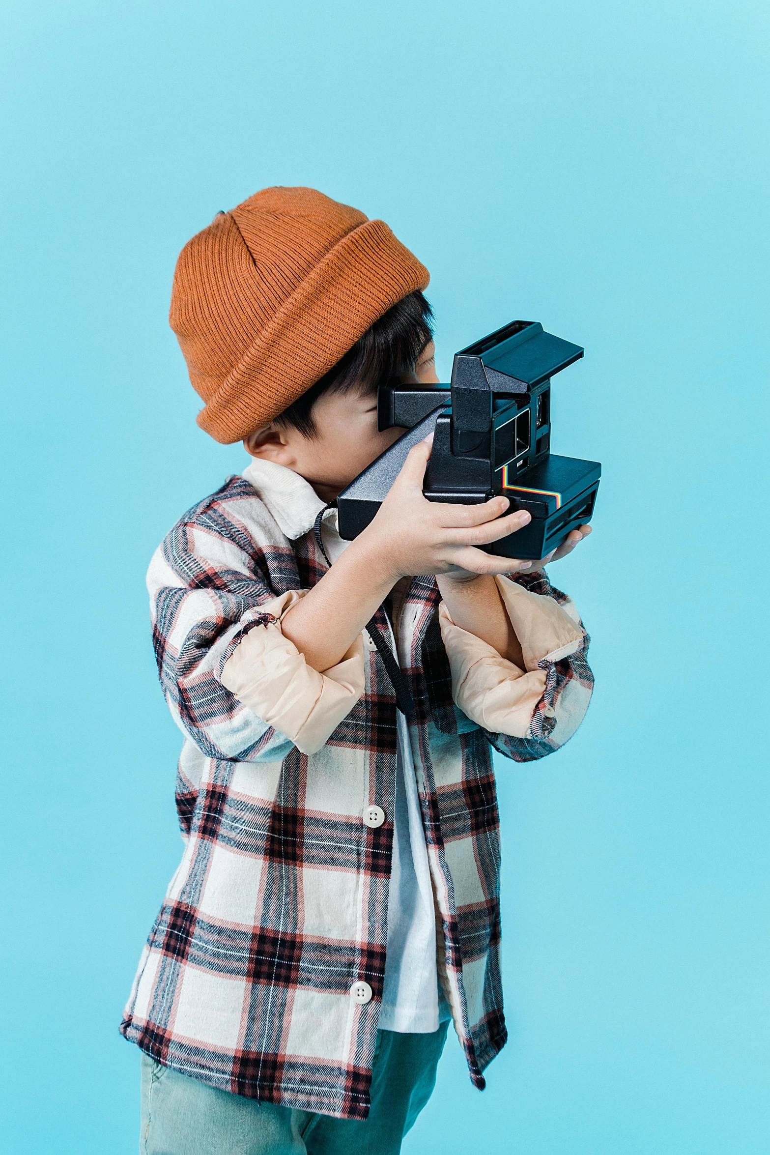 a little boy with a camera on a blue background, unsplash, hypermodernism, caracter with brown hat, wearing vr, toy photo, instagram post