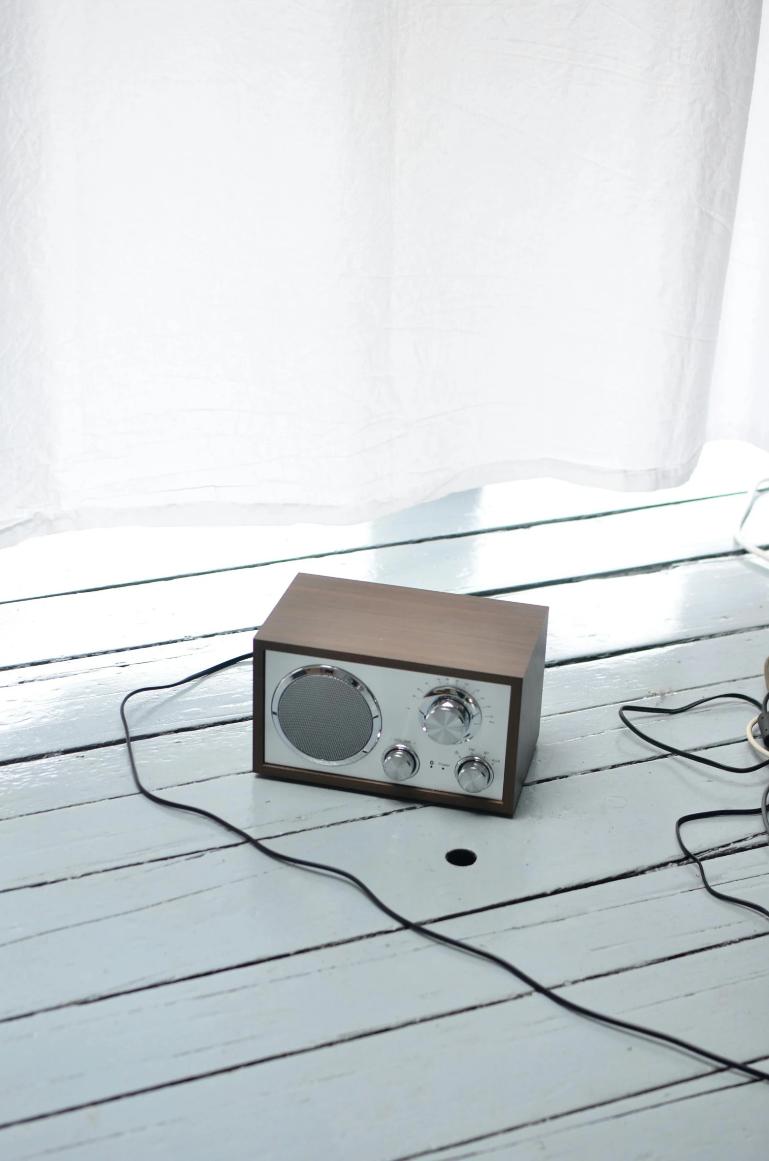 a radio sitting on top of a wooden floor next to a window, by Eero Järnefelt, copper, small, portrait n - 9, mint