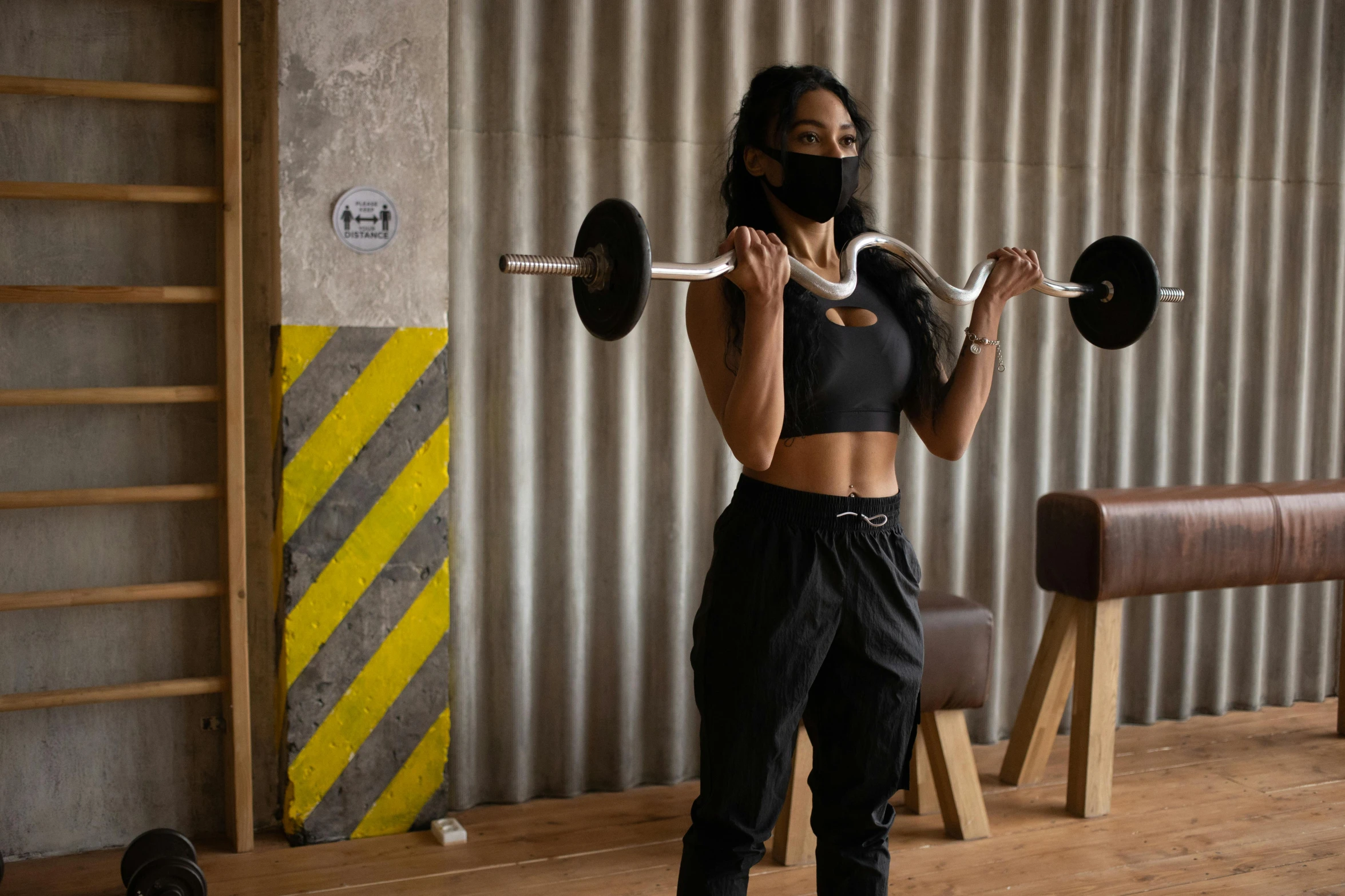 a woman lifting a barbell in a gym, pexels contest winner, private press, wearing bandit mask, closed limbo room, riyahd cassiem, carrying two barbells