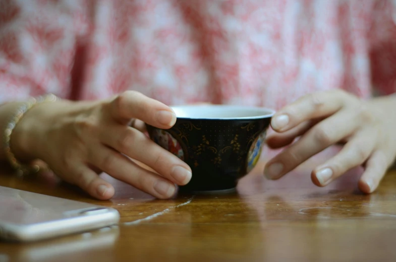 a person sitting at a table with a cup of coffee, by Alice Mason, pexels, kintsugi, praying, 15081959 21121991 01012000 4k, close up of iwakura lain