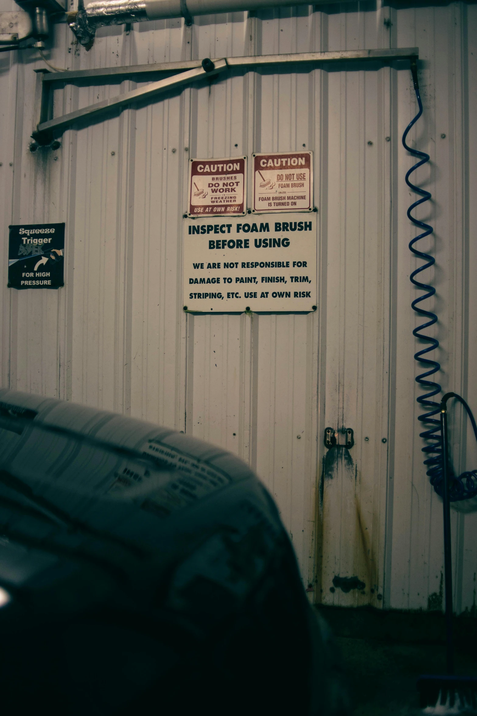 a car parked in front of a garage door, sign, smokey tires, in a workshop, tyler west