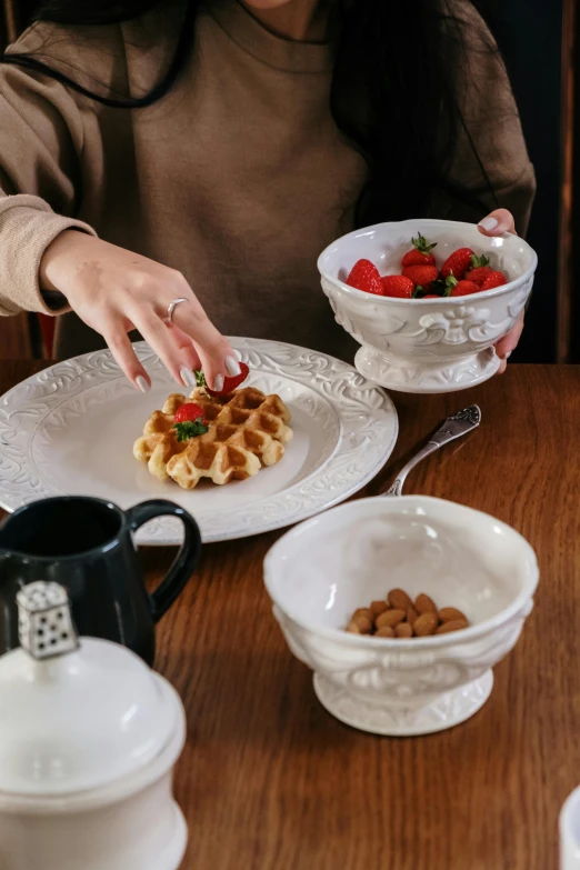 a woman sitting at a table with plates of food, a still life, inspired by Richmond Barthé, trending on pexels, renaissance, stroopwaffel, embossed, raspberry, bowl