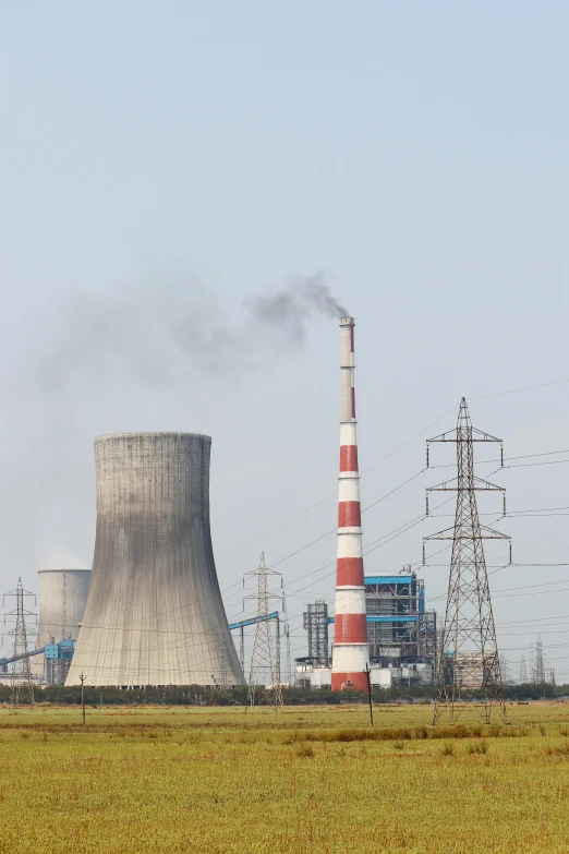 a large factory with a lot of smoke coming out of it, a picture, shutterstock, power plants, 2263539546], pylons, beijing
