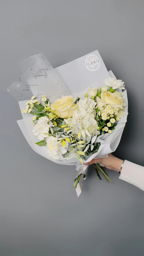 a person holding a bouquet of white and yellow flowers, full product shot, light grey mist, paper, 'groovy'