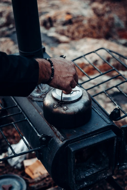 a close up of a person cooking on a stove, mate, rugged details, holding a drink, grey