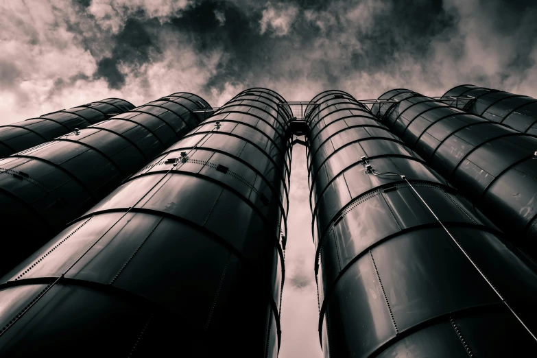 a black and white photo of a tall building, by Adam Marczyński, pexels contest winner, barrels, biotech, monochrome color, leading to the sky