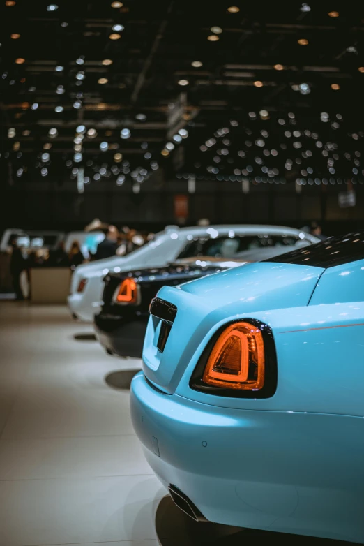 a row of cars on display in a showroom, pexels contest winner, renaissance, pale blue backlight, wraith, thumbnail, 8l