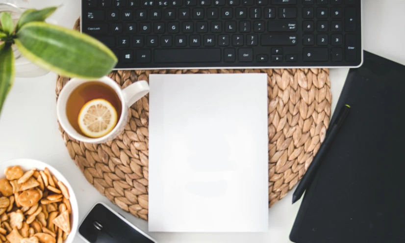 a laptop computer sitting on top of a table next to a cup of tea, trending on pexels, arbeitsrat für kunst, white paper, background image, writing a letter, circular shape