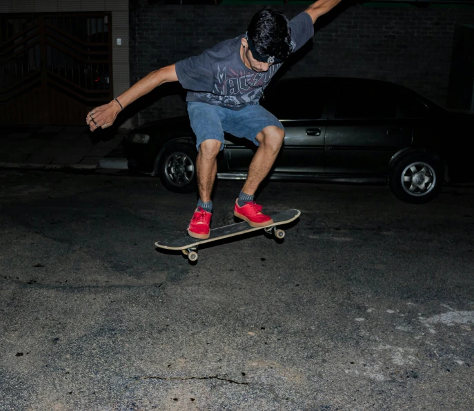 a man flying through the air while riding a skateboard, by Alejandro Obregón, pexels contest winner, realism, harsh flash photo at night, low quality footage, car jump, 2 0 0 0's photo