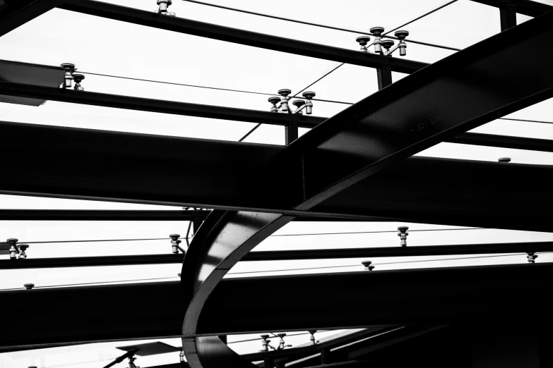 a black and white photo of the inside of a building, by Jacob Toorenvliet, overpass, metal joints, lights, tourist photo