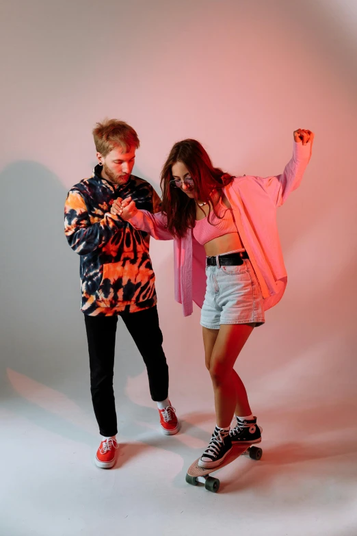 a man and a woman standing next to each other, an album cover, unsplash, fight pose, dayglo pink, cardigan, caspar david