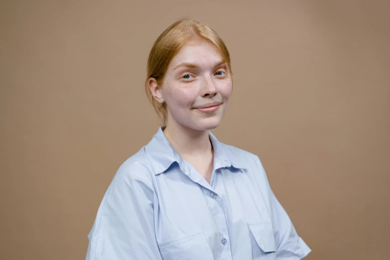 a woman in a blue shirt posing for a picture, with pale skin, russian academic, brown:-2, official product photo