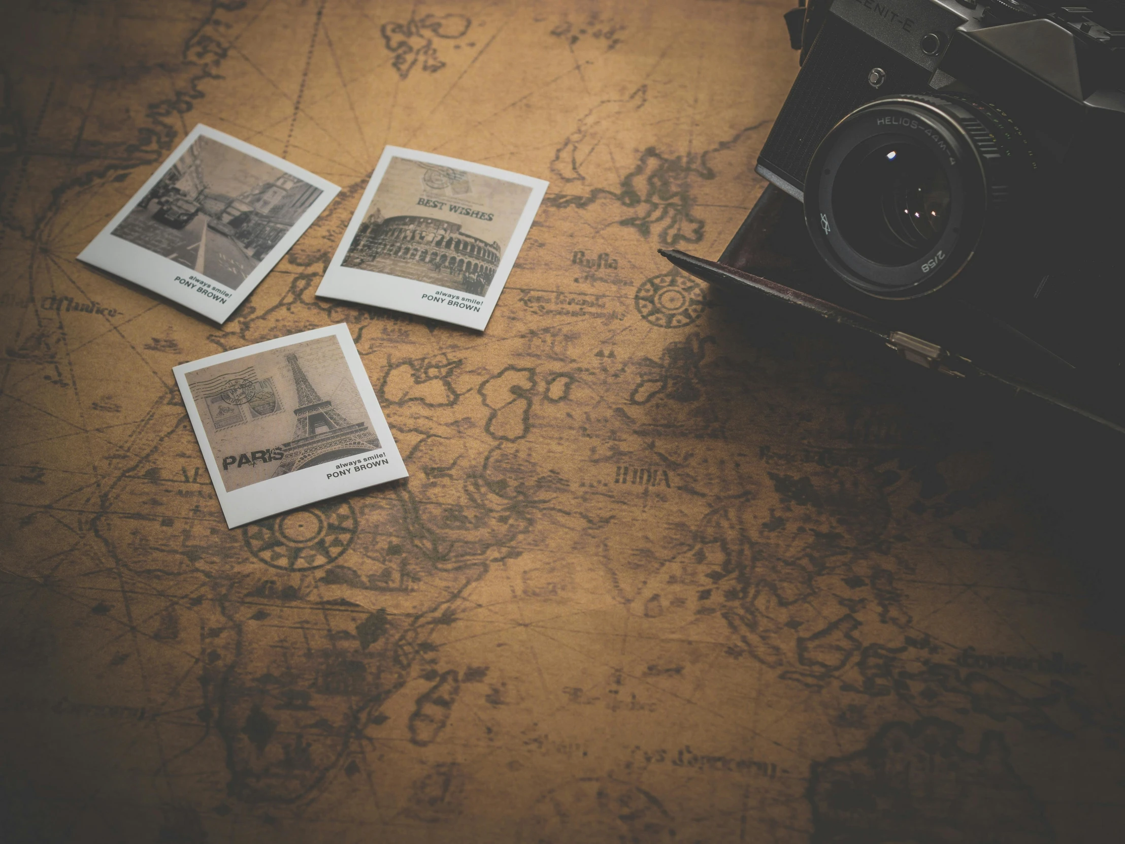 a camera sitting on top of a wooden table, a polaroid photo, pexels contest winner, visual art, map cartography, several continents, brown, old film overlay