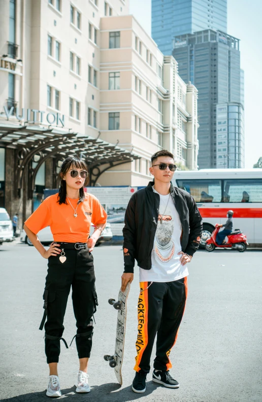 a couple of people that are standing in the street, trending on pexels, in style of lam manh, gang clothing, tilt and orange, 000 — википедия