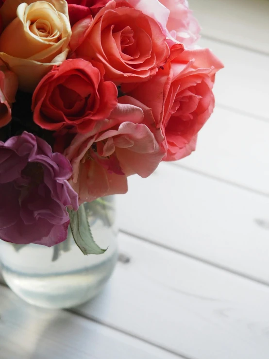 a close up of a vase of flowers on a table, up-close, product shot, roses, close-up photograph