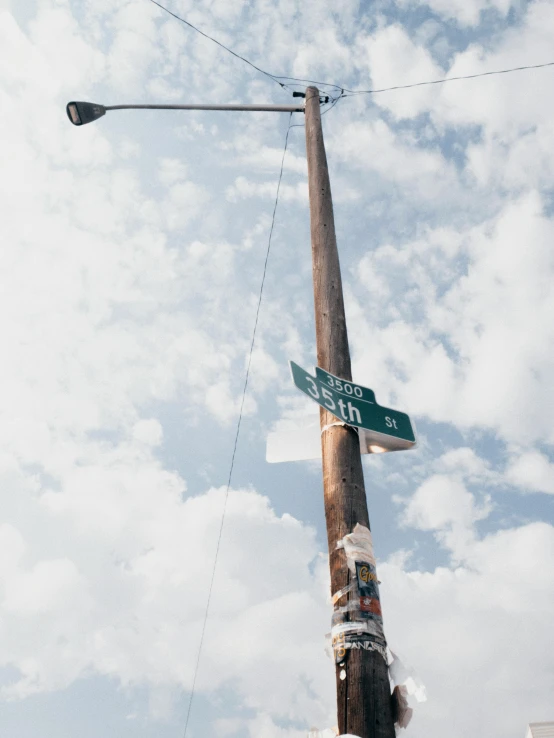 a street sign sitting on top of a wooden pole, an album cover, unsplash, ignant, in an american suburb, highest detail, public art