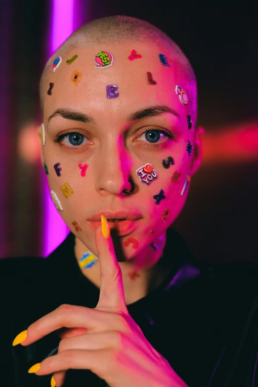 a woman with lots of stickers on her face, a tattoo, inspired by Elsa Bleda, trending on pexels, antipodeans, shaved bald head, charli xcx, face icon, bisexual lighting