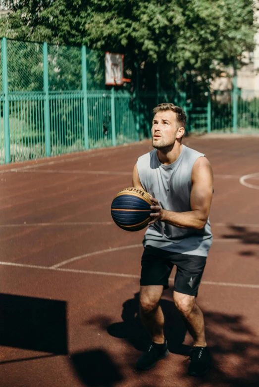 a man standing on a basketball court holding a basketball, by Kazimierz Wojniakowski, dribble, tight black tank top and shorts, working out, wearing : tanktop, trending photo