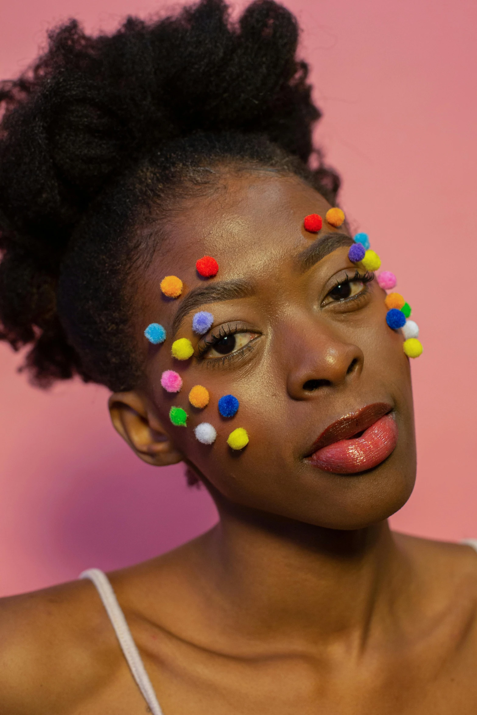 a woman with colorful confetti on her face, an album cover, inspired by Okuda Gensō, trending on pexels, afrofuturism, pincushion lens effect, made out of sweets, polkadots, black teenage girl
