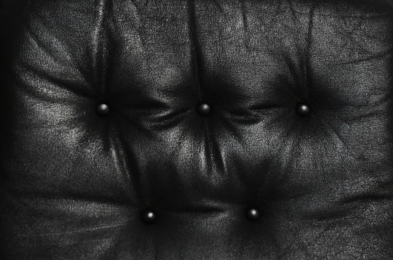 a close up of a black leather chair, a stipple, by Daniel Gelon, baroque, seventies, tufted softly, hq textures, rivets