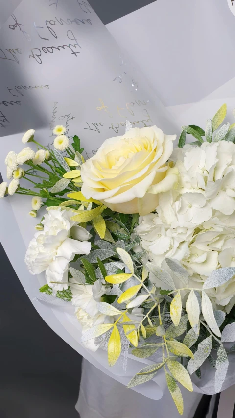 a woman holding a bouquet of white and yellow flowers, reassuring, no cropping, white and grey, up close