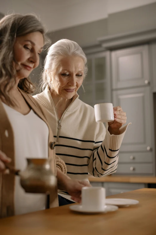 a couple of women standing next to each other in a kitchen, pexels contest winner, renaissance, with a white mug, older woman, 15081959 21121991 01012000 4k, multi-dimensional
