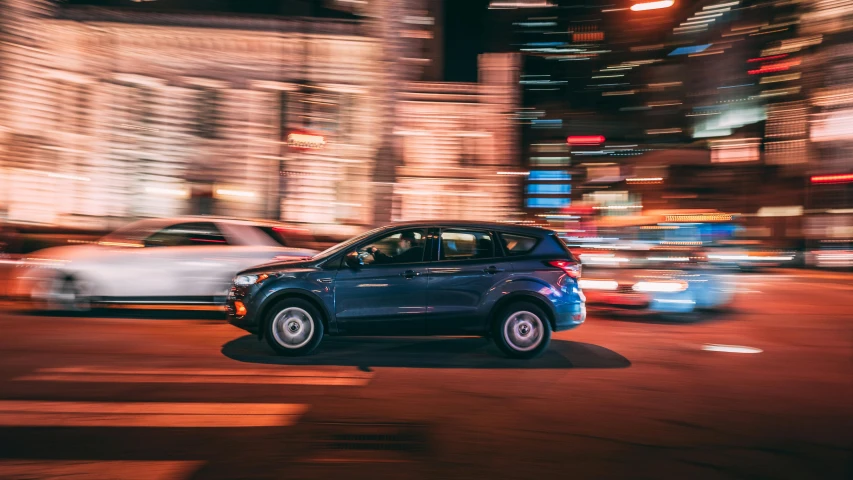 a car driving down a city street at night, by Carey Morris, pexels contest winner, ford fusion, fan favorite, charging through city, super high resolution