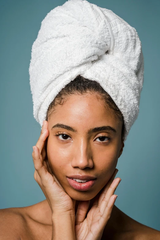 a woman with a towel on her head, by Carey Morris, trending on pexels, renaissance, ashteroth, oriental face, studio photo, medium skin tone