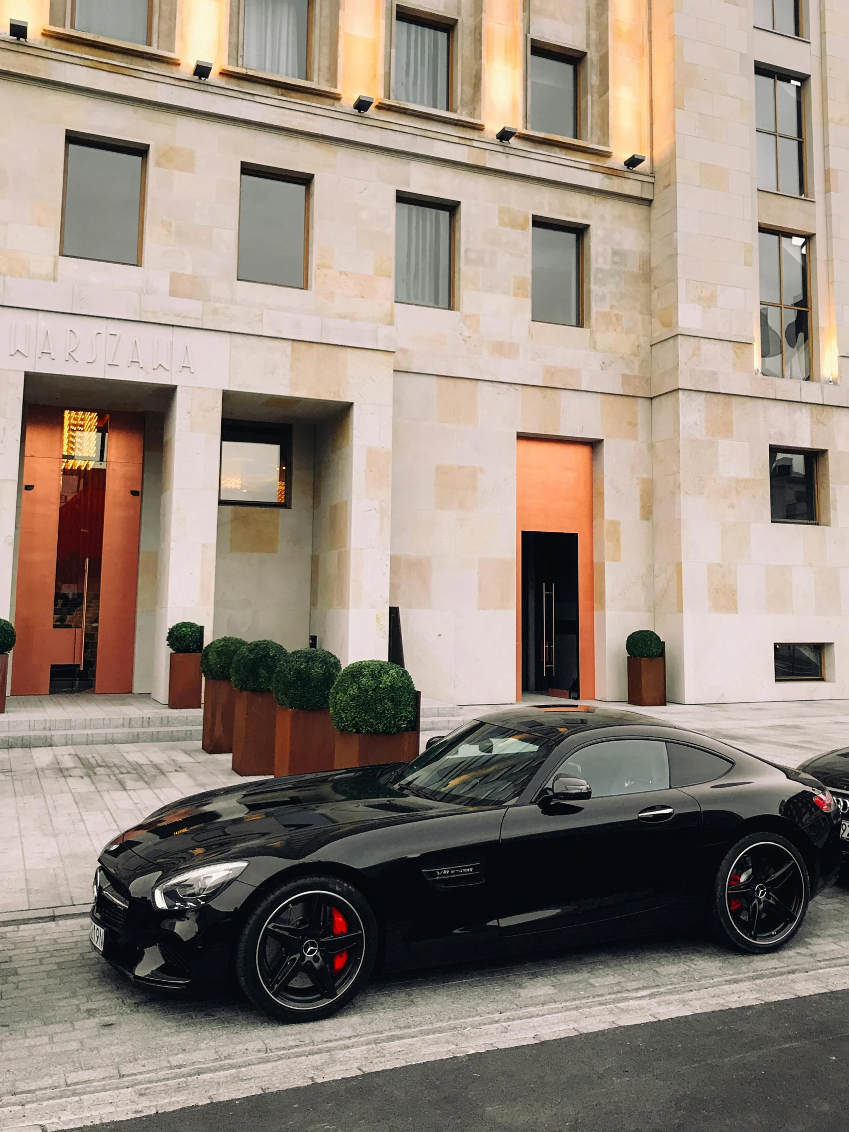 two black sports cars parked in front of a building, 🚿🗝📝, bulgari, mercedez benz, vienna city