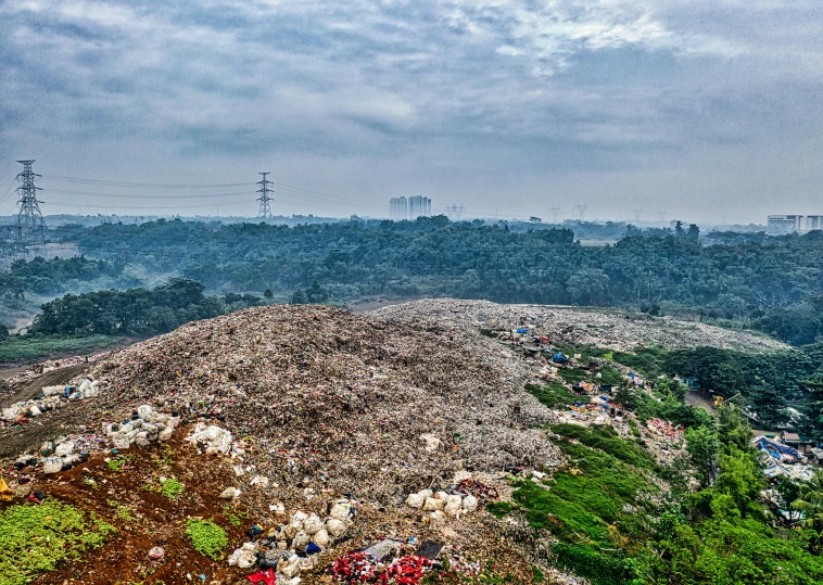 a large pile of garbage sitting on top of a lush green hillside, by Daniel Lieske, unsplash contest winner, jakarta, panoramic, promo image, “diamonds