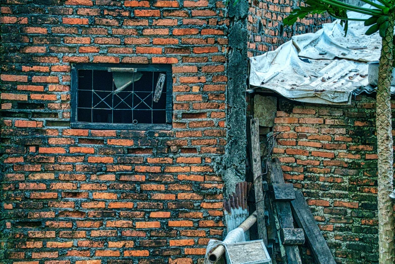 a fire hydrant sitting next to a brick building, a photo, by Jan Tengnagel, pexels contest winner, realism, old dhaka, background image, thatched roofs, in a small prison cell