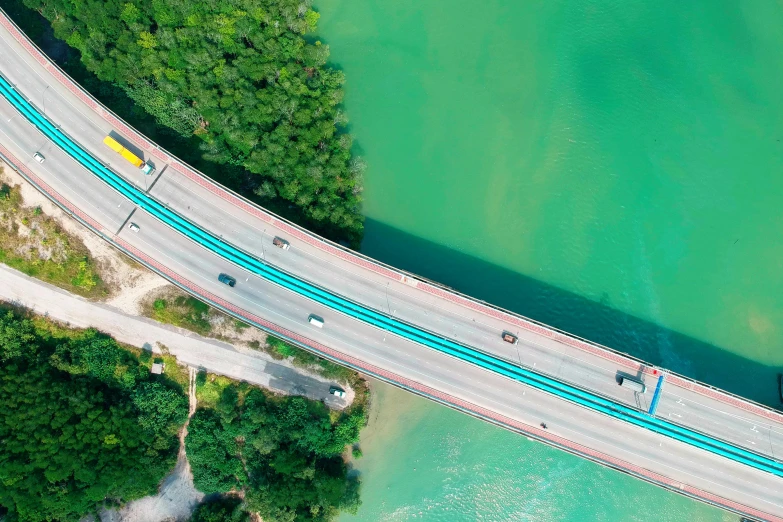 an aerial view of a bridge over a body of water, pexels contest winner, cars on the road, blue and green water, composite, thumbnail