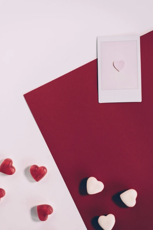 a valentine's day card with hearts on a red and white background, a picture, by Valentine Hugo, pexels contest winner, dreamy kodak color stock, maroon and white, scattered props, elegant minimalism