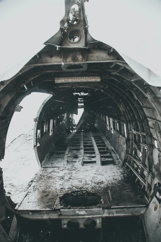 a black and white photo of a train inside of a tunnel, pexels contest winner, auto-destructive art, ground covered with snow, aircraft wings on back, iceland, vintage color