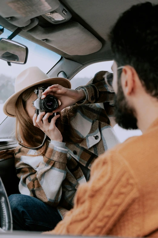 a man taking a picture of a woman in a car, a picture, pexels contest winner, telephoto vacation picture, holding a camera, detailing, mid body shot