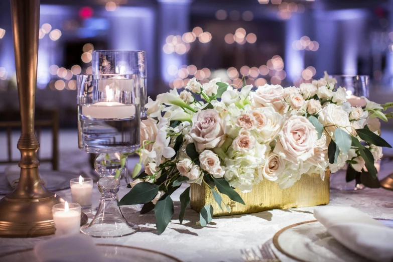 a vase filled with white flowers sitting on top of a table, by Robbie Trevino, evening lighting, lavishly decorated, pastel roses, liquid gold