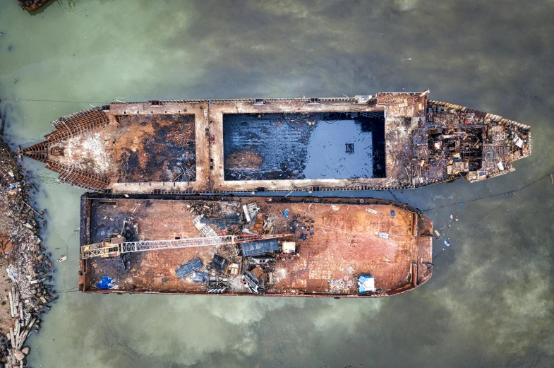 a couple of boats sitting on top of a body of water, a portrait, unsplash contest winner, auto-destructive art, bioremediation, drone photo, utilitarian cargo ship, hong lei