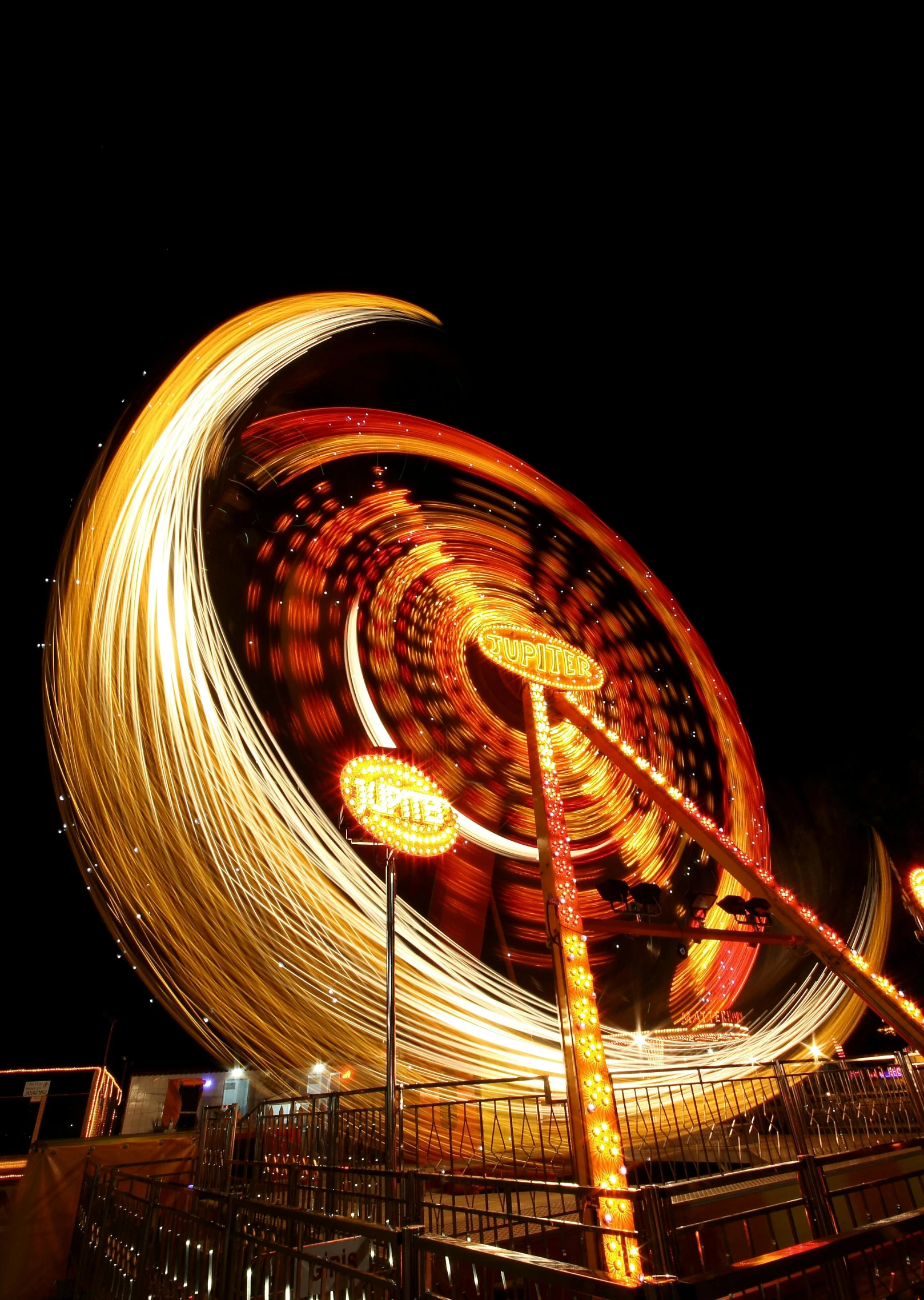 a close up of a ferris wheel at night