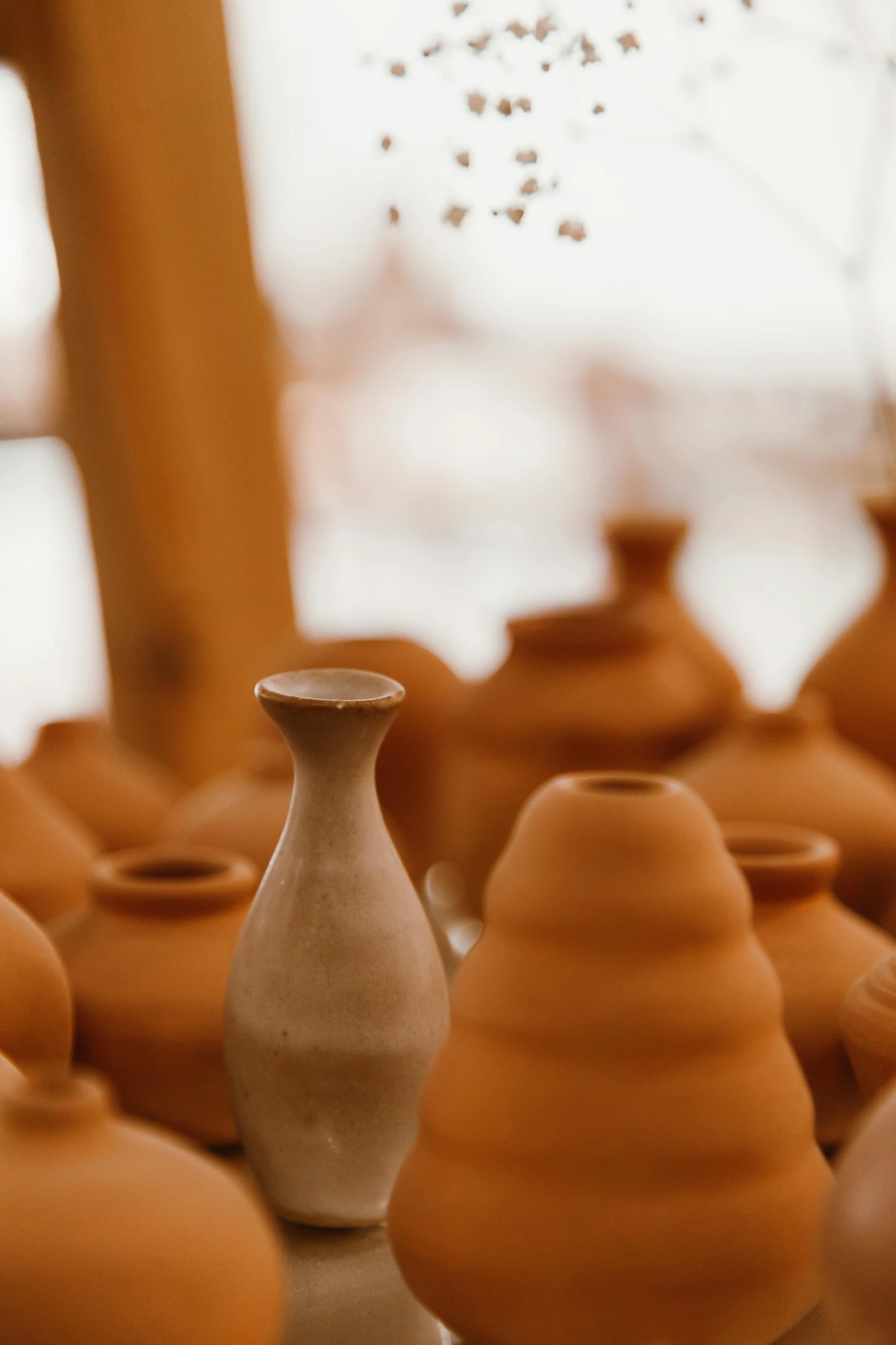 a group of clay pots sitting on top of a table, upclose, up-close, vase, shot on sony a 7 iii