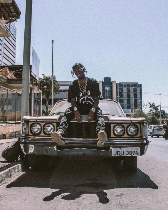 a man sitting on the hood of a car, an album cover, trending on unsplash, elephant man, high quality photo, wearing shades, profile image