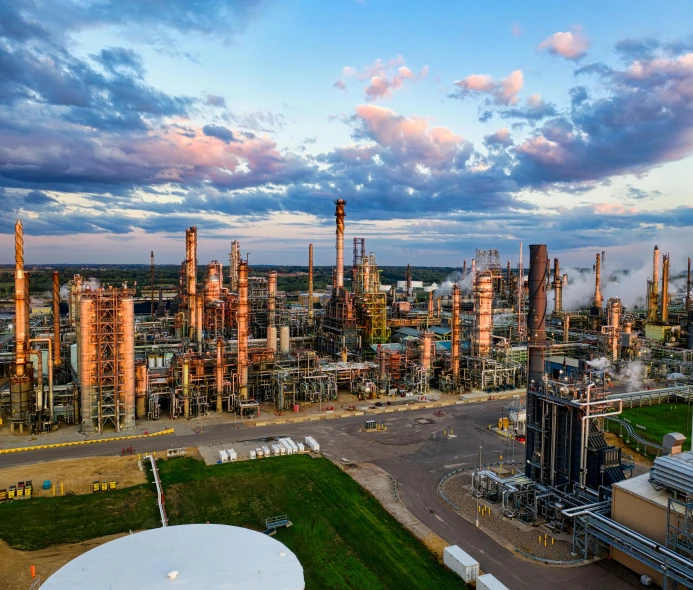 an oil refinery in the middle of a field, a portrait, pexels contest winner, epic lighting from above, greg rutkovsky, vibrant scene, journalism photo