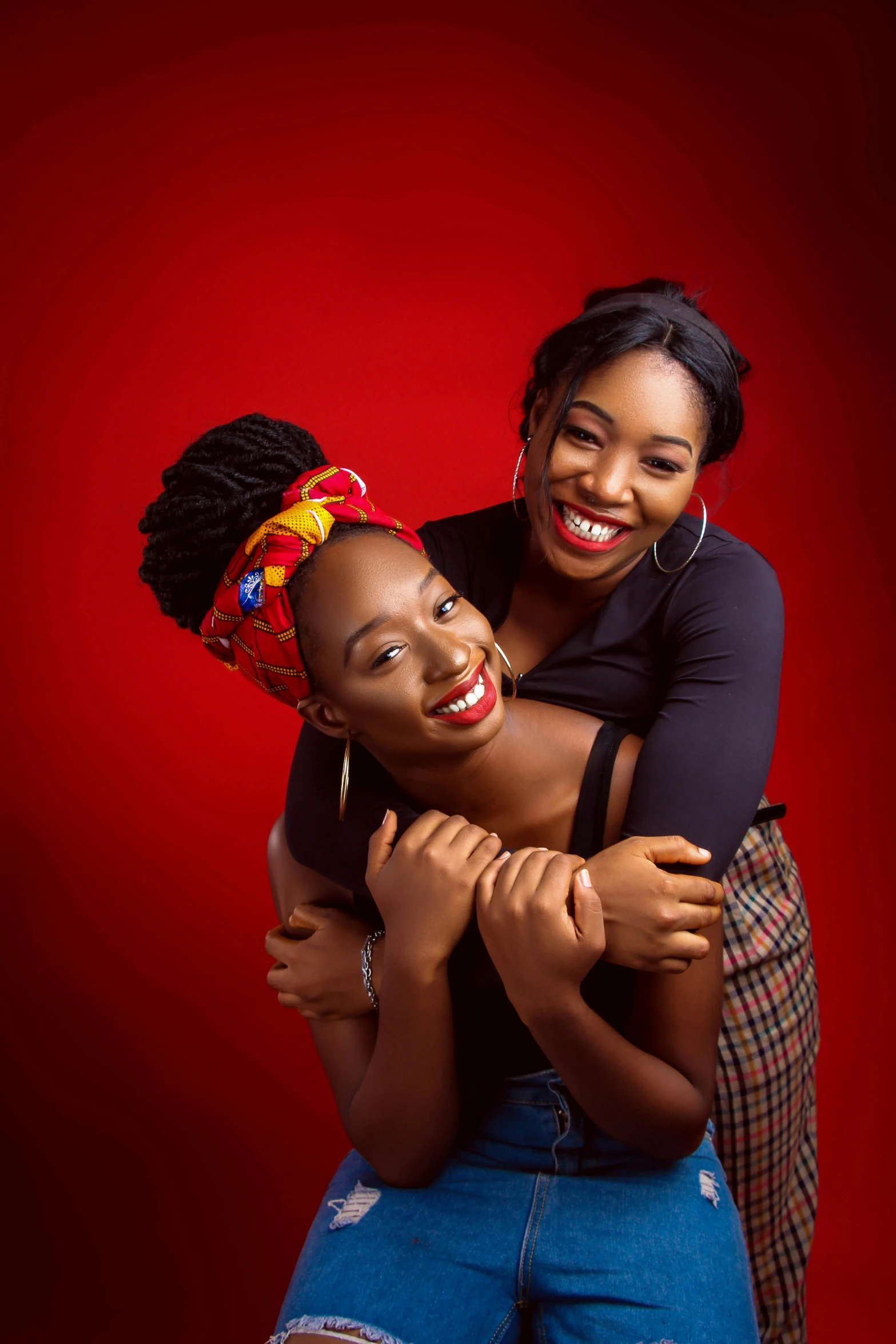 a couple of women standing next to each other, a portrait, by Chinwe Chukwuogo-Roy, shutterstock contest winner, cheeky smile with red lips, studio shoot, square, friendship