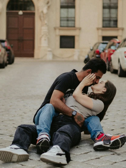 a man and woman sitting on the ground in front of a building, pexels contest winner, happening, making out, eternal city, on a parking lot, high resolution photo
