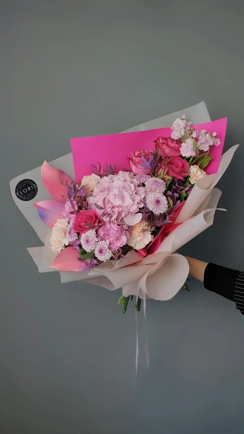 a woman holding a bouquet of pink and white flowers, inspired by François Boquet, instagram, with fluo colored details, foil, perfect design, wrapped in flowers