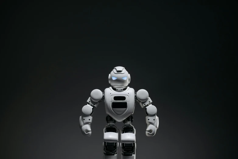 a close up of a toy robot on a black background, a digital rendering, unsplash, on a gray background, < full body robot >, eye - level view, 3/4 front view