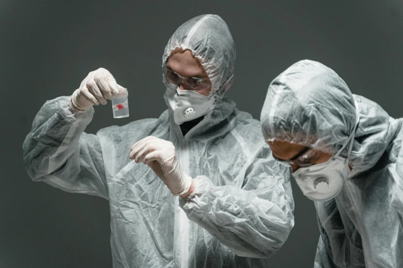 a couple of men standing next to each other, shutterstock, plasticien, technical suit, holding syringe, grey robes, ergodox