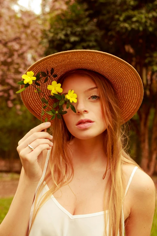a woman in a hat holding a bunch of flowers, an album cover, inspired by Oleg Oprisco, unsplash, portrait anya taylor-joy, yellow sunshine, sophie turner girl, perfect face model